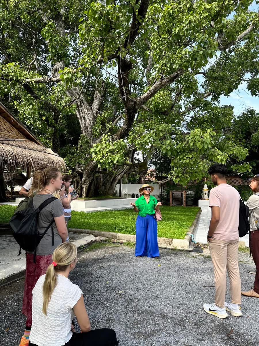 Food walk guide sharing stories under a bodhi tree